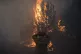 A firefighter adjusts his helmet in Varnava village during a