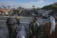 Palestinians survey the aftermath of an Israeli air strike o