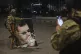 A Syrian opposition fighter takes a picture of a comrade ste