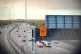 Activists from Just Stop Oil hang a banner above the M25
