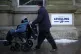 Shoppers walk past a 'Powered By Levelling Up' sign recently