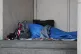 A homeless person sleeping rough in a doorway