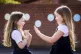two children playing patty cake during their lunch break in 