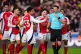 Arsenal players confront referee Michael Oliver after showin