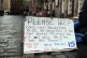 12/01/18 of a sign near a homeless person and their dog on t